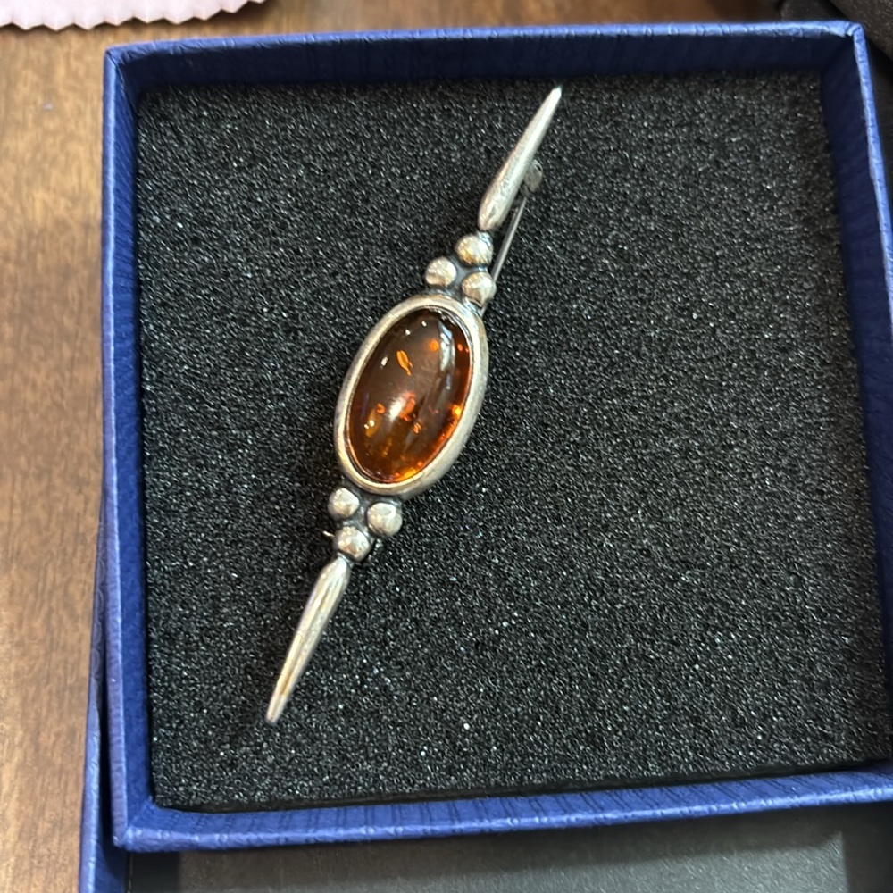 vintage sterling silver bar brooch set with a polished amber stone